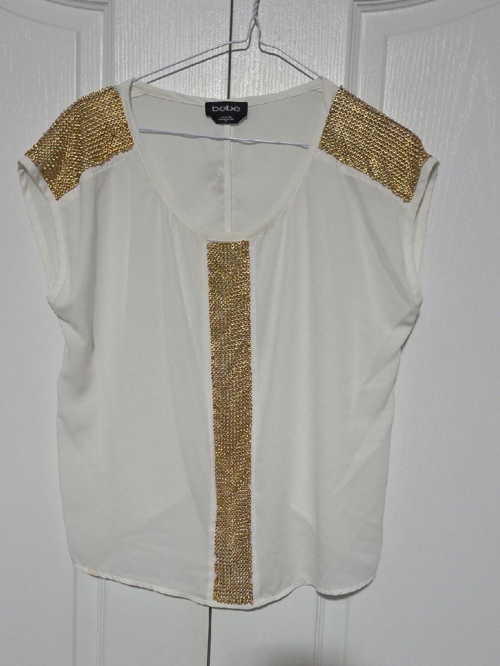 bebe Ivory Sleeveless Blouse with Gold Chain Accents